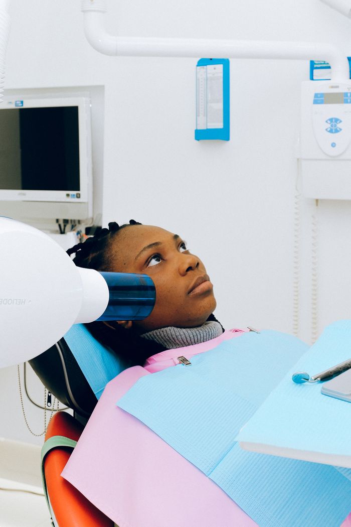 The Art of Drawing Readers In: Your attractive post title goes here A woman receiving a dental X-ray in a modern clinic setting. Healthcare and technology in action.